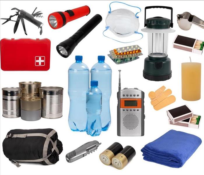An emergency kit, it has water bottles, flashlights, batteries, medicine, matches, sleeping bag and blanket